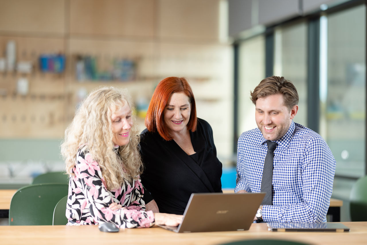 Teachers at a computer