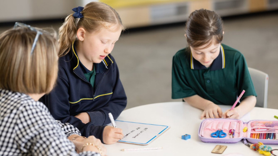 teacher helping children